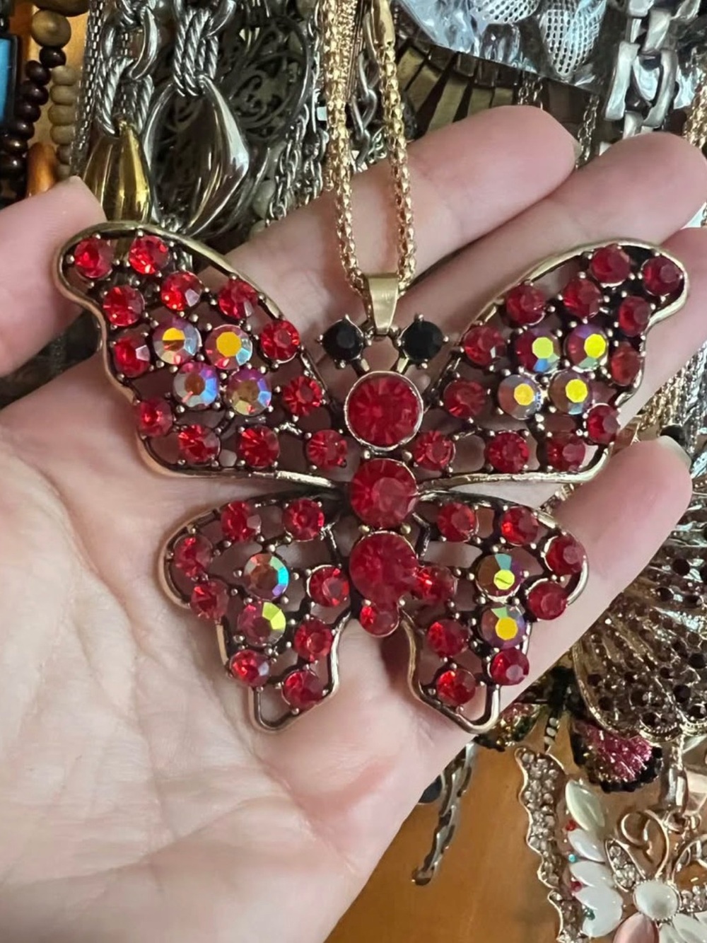 Butterfly necklace. Gold tone chain. Red rhinestones . Lobster clasp